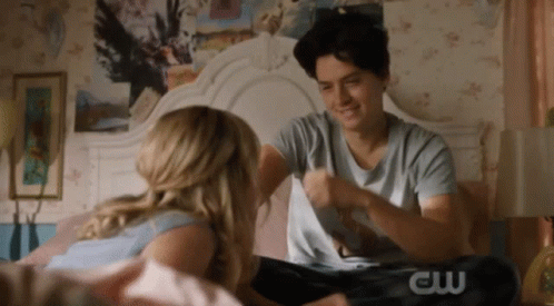 Couple Sitting On Bed Man Wearing CW Shirt GIF