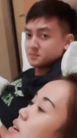 Couple Sitting On Bed Woman Looking At Man GIF