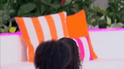 Couple Sitting On Couch With Pillows GIF