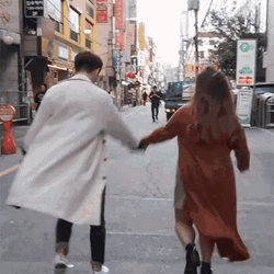 Couple Skipping In Street