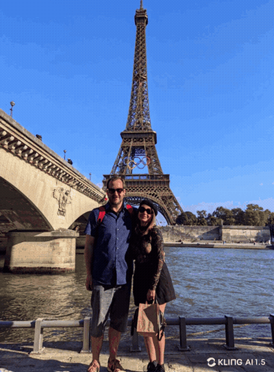 Couple Standing In Front Of Eiffel Tower GIF