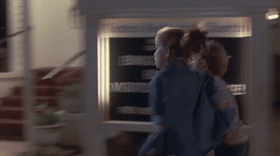 Couple Standing In Front Of Welcome Sign GIF