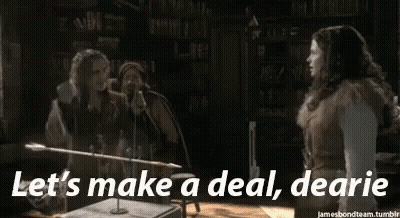 Couple Standing Next To Each Other Saying Let's Make A Deal Dearie GIF
