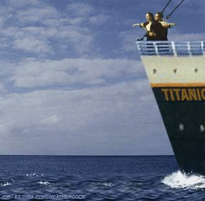 Couple Standing On Titanic Boat In Ocean GIF