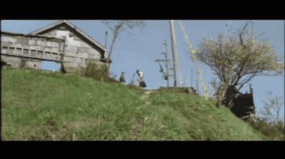 Couple Walking Down Hill In Front Of House GIF