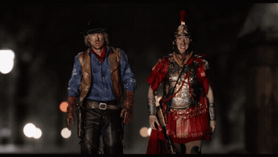 Cowboy And Roman Soldier Standing Together GIF