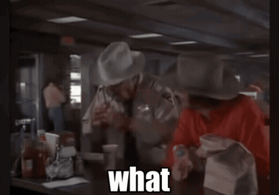 Cowboy Hat Man Calling Suit Man A Mental Case GIF