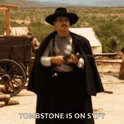 Cowboy Hat Man Holding Gun Saying Tombstone Is On Syfy GIF
