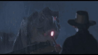 Cowboy Hat Man In Front Of Dinosaur With Flashlight GIF