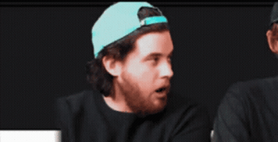 Cowboy Hat Man Looking At Baseball Cap Man GIF