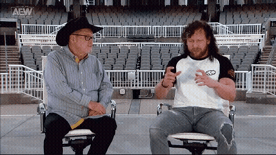 Cowboy Hat Man Next To Man With AEW Logo GIF