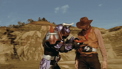 Cowboy Hat Man Next To Purple Superhero GIF