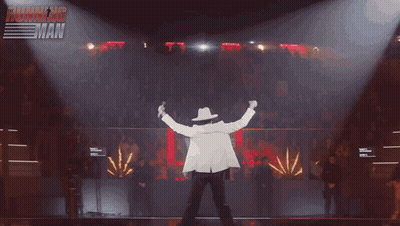 Cowboy Hat Man On Stage With Fireworks And Ultimate Muscleman Sign GIF