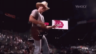Cowboy Hat Man Playing Guitar On Stage GIF