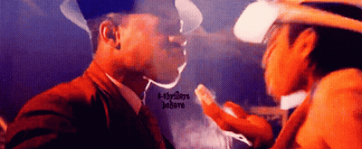 Cowboy Hat Man Smoking Next To Man In Suit GIF