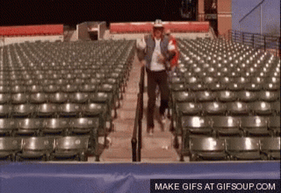 Cowboy Hat Man Walking Down Stadium Stairs GIF