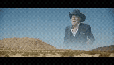 Cowboy In Desert Hands In Air GIF