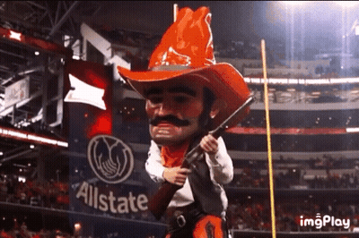 Cowboy Mascot Holding Gun In Front Of Allstate Banner GIF