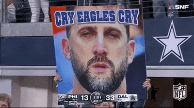 Cowboys Fan Holds Sign Saying Cry Eagles Cry GIF