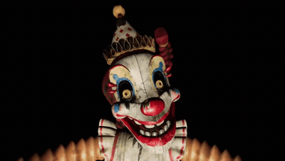 Creepy Clown With Crown Looking At Camera GIF