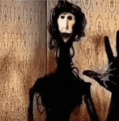 Creepy Doll Standing In Dark Room GIF