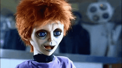 Creepy Doll With Red Hair And Blue Eyes In Purple Shirt GIF