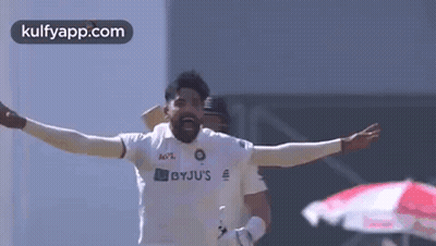 Cricket Player Celebrating With Arms Outstretched