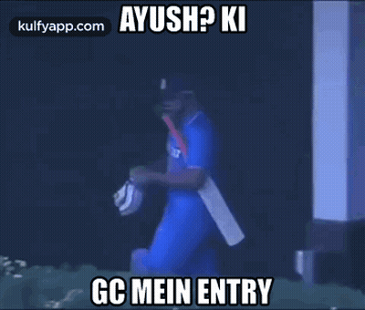 Cricket Player Walking in Dark Room With Bat and Mask