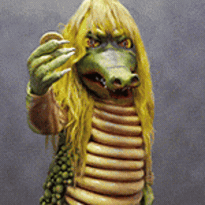 Crocodile Statue With Yellow Hair And Sharp Claws GIF