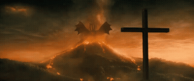 Cross In Front Of Volcano With Dragon Flying GIF