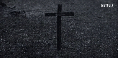 Cross With Regina Written In Dirt GIF