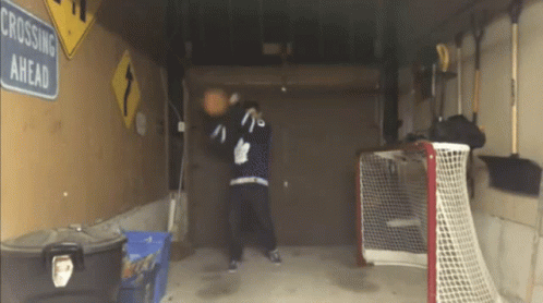 Crossing Ahead Sign Hanging In Garage GIF