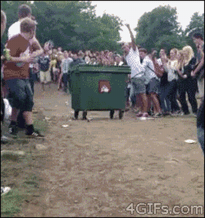 Crowd Around Green Recycling Dumpster GIF