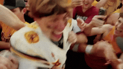 Crowd Around Man In White Shirt With Yellow Star GIF