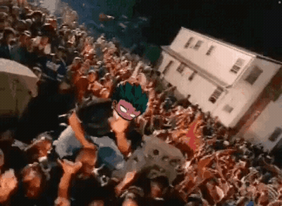Crowd Around Stage With Masked Man GIF
