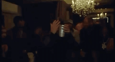 Crowd Dancing in Dark Room with Chandelier