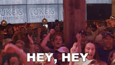 Crowd Dancing In Front Of Luke's Bridge Sign GIF