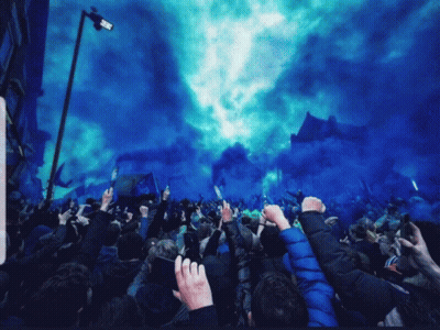 Crowd Fists Raised With Blue Smoke GIF
