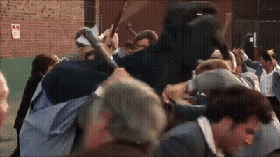 Crowd Gathered In Front Of Brick Building GIF