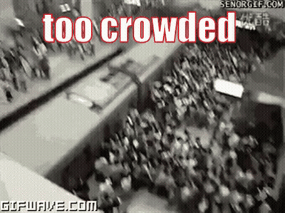 Crowd Gathered In Front Of Sign Reading Too Crowded GIF