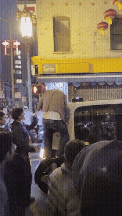 Crowd Gathered In Front Of Sprite Building GIF
