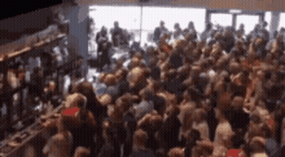 Crowd Gathered In Room By Window GIF