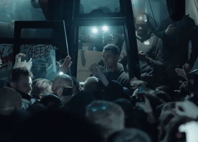 Crowd Gathering In Dark Room Cheer Sign GIF