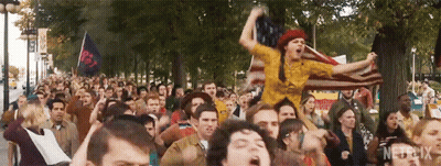 Crowd Holding American Flag In Park GIF