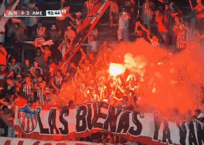 Crowd Holding Banner Saying Las Buena GIF