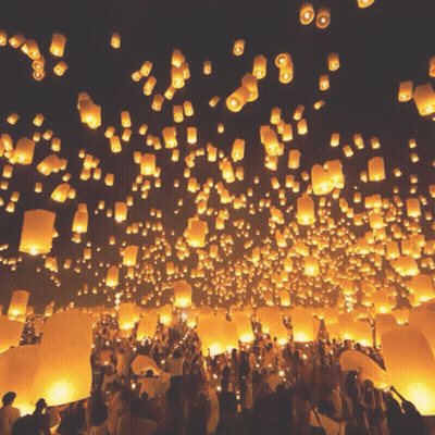 Crowd Holding Lanterns At Night GIF