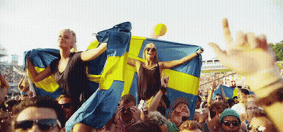 Crowd Holding Swedish Flags GIF