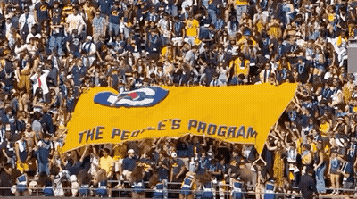 Crowd Holding Yellow Banner Saying The Peoples Program GIF
