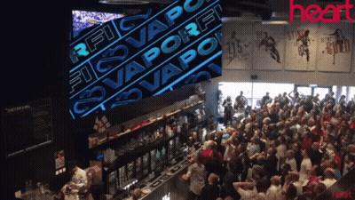 Crowd In Bar With Rfc Vaporfi Sign GIF