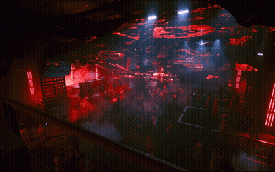 Crowd In Dark Room With Red Ceiling Lights GIF
